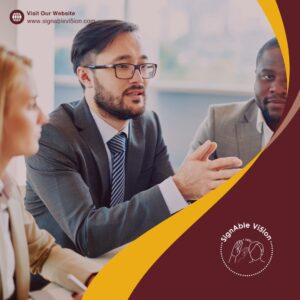 A man in a suit speaks during a business meeting, gesturing with his hands while two colleagues listen. Branded overlay with the SignAble Vi5ion logo and website link frames the image.