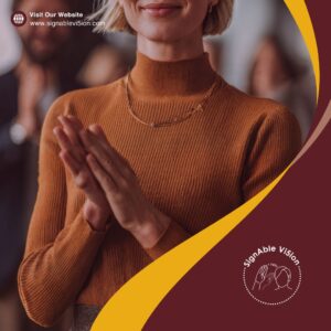 The image shows a close-up of a person clapping, captured from the shoulders down. They’re wearing a ribbed, long-sleeve, burnt-orange turtleneck. The background is softly blurred, suggesting they’re in a group or audience. The design includes curved maroon and yellow shapes framing the photo, along with the SignAble Vi5ion logo and a “Visit Our Website” text with the URL in the top corner.