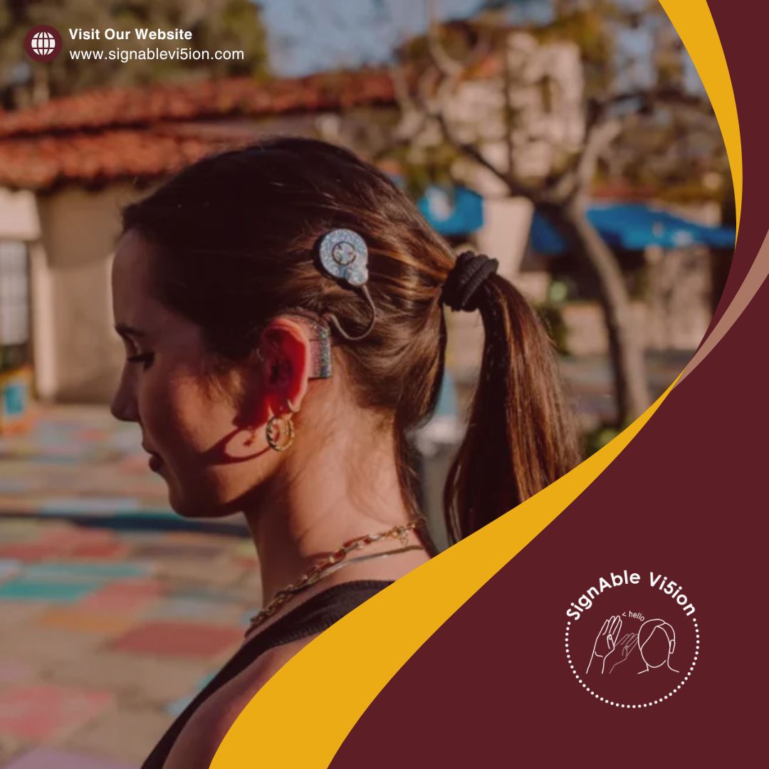 A young woman is shown in profile wearing a cochlear implant. Her hair is tied back in a ponytail, and she is standing outdoors in warm sunlight. The SignAble Vi5ion branding frames the image with maroon and gold accents, along with the website link at the top.
