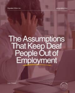 A promotional graphic by SignAble Vi5ion Inc. features a person sitting at a desk in front of a laptop, leaning forward with one hand covering their face, suggesting frustration or stress. The background shows an office setting with a muted burgundy overlay. Large white text in the centre reads: “The Assumptions That Keep Deaf People Out of Employment” with a yellow brushstroke underline. At the top, “SignAble Vi5ion Inc.” appears on the left and “@signablevi5ion” on the right. At the bottom, “Leah Riddell” appears on the left, with the SignAble Vi5ion logo on the right.
